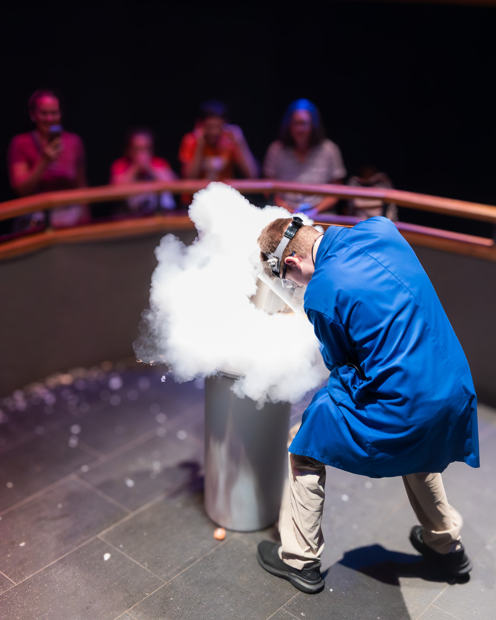 Noah Albers giving a science demonstration at Science North, a cloud of vapor rising from a canister